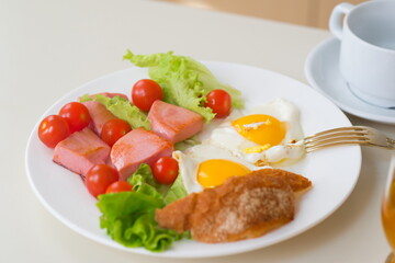 fried eggs with bacon and vegetables