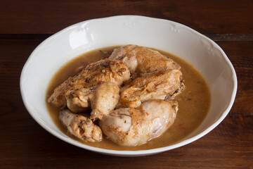 Presentation plating food of chicken in vegetable sauce with cognac on a wooden table. Cooking recipes at home. Meat, and vegetables.