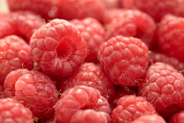 Closeup shot of sweet and ripe raspberries on a blurred background