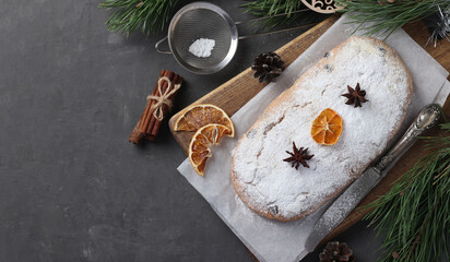 Christmas tasty stollen with dry fruits, berries and nuts on wooden board. Traditional German treats.
