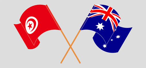 Crossed and waving flags of Tunisia and Australia