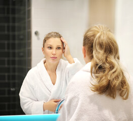 Fototapeta premium Magic anti-aging cream.Applying the cream. woman moisturizing face mask. Cosmetology and skin care concept..