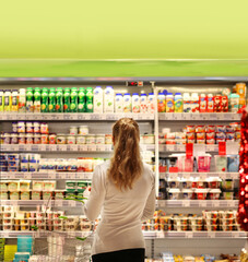 supermarket shopping, face mask,Woman choosing a dairy products at supermarket.