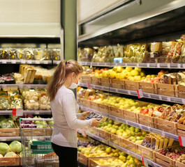 Supermarket shopping, face mask ,woman buying fruits  at the market.