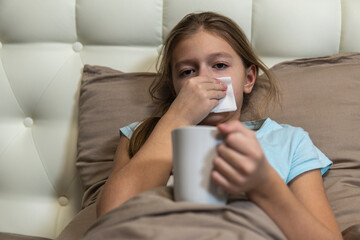 Girl with dark hair sick in bed