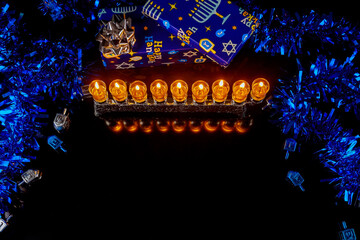 Jewish holiday Hanukkah background with burning candles on menorah and gift boxes. .