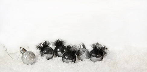 Christmas silver and black balloons and snow on a white background.