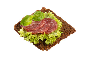 Variety of mini sandwiches with cream cheese, vegetables and salami.