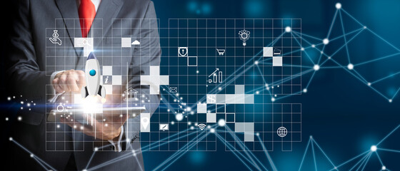 Businessman with a tablet launching a virtual rocket as the start of a business. Business concept, growth and marketing