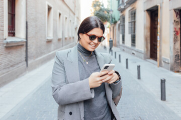 Young woman smiling using smart phone