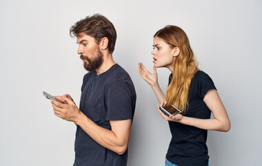 young couple with a phone in their hands emotions family communication discontent