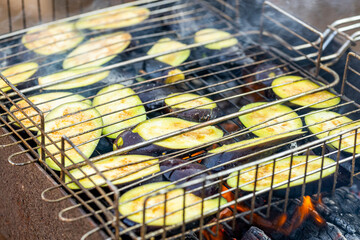 barbeque cooking aubergine or eggplant on fire. grilled dish outdoors
