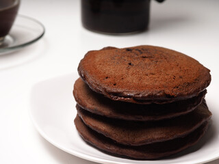 Close up shoot of stacked brown chocolate flafor pancake on an isolated white background