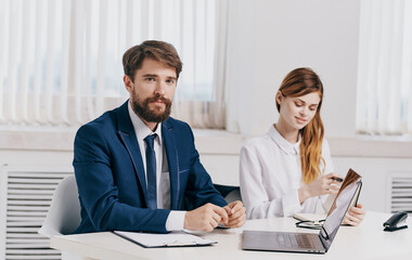 Fototapeta premium man and woman with laptop in office communication employees business finance