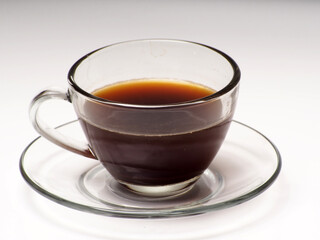 A cup of coffee and french press on a white isolated background