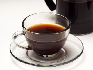 A cup of coffee and french press on a white isolated background