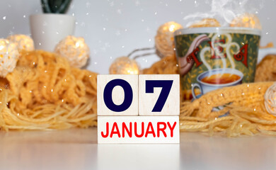 Cube shape calendar for January 07 on wooden surface with empty space for text.
