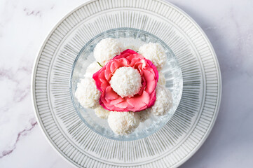 Coconut balls, ehite chocolate rafaello candies. Vegetarian round tasty dessert for romantic celebration