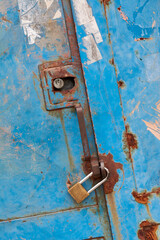 Rustic iron door with closed padlock