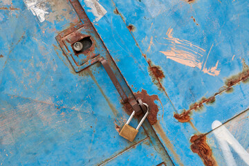 Rustic iron door with closed padlock