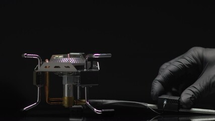 Person hand turns on kitchen cooktop gas burner with blue flame.
Electric circuit breaker ignites natural gas in the stove. - Powered by Adobe