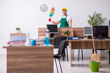 Fototapeta premium Young male contractor cleaning the office