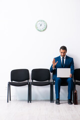Young businessman waiting for an interview at hall