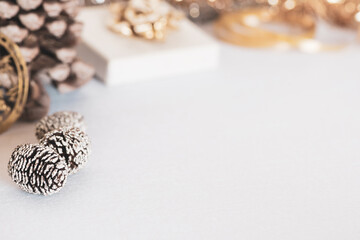 Christmas decorations - pinecones and golden ribbons on a white background