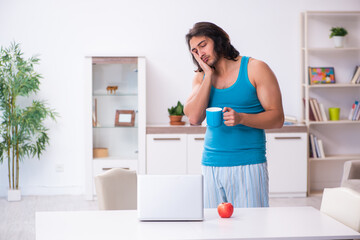 Young man waking up at home