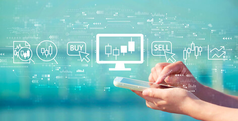 Obraz na płótnie Canvas Stock trading theme with person holding a white smartphone