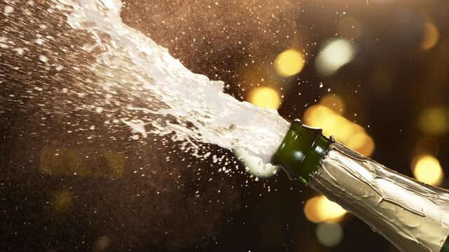 Super slow motion of Champagne explosion, opening champagne bottle closeup. Filmed on high speed cinema camera, 1000fps