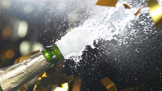 Super slow motion of Champagne explosion, opening champagne bottle closeup. Filmed on high speed cinema camera, 1000fps
