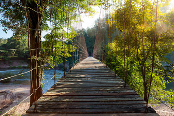 wooden foot bridge across river