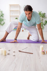 Young man during yoga session at home