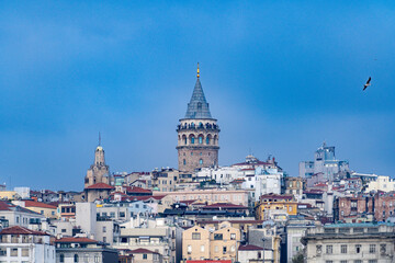 Fototapeta na wymiar Galata town and the Tower from historical peninsula durning a ferryboat passing on Bosporus.Sky is clear partly cloudy on istanbul