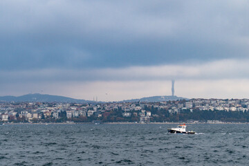 Boat and a ferry at the Bosporus on a cloudy day but clear weather