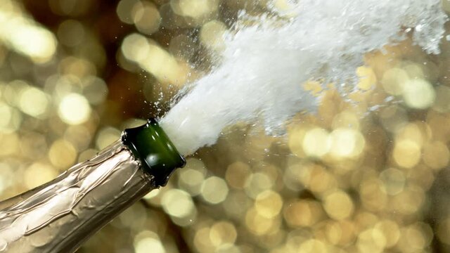 Super slow motion of Champagne explosion, opening champagne bottle closeup. Filmed on high speed cinema camera, 2000fps