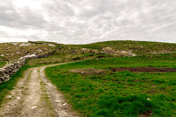 Start of a short hiking track to Mastravarden top hill at Mosteroy island, Rennesoy commune, Stavanger, Norway, May 2018