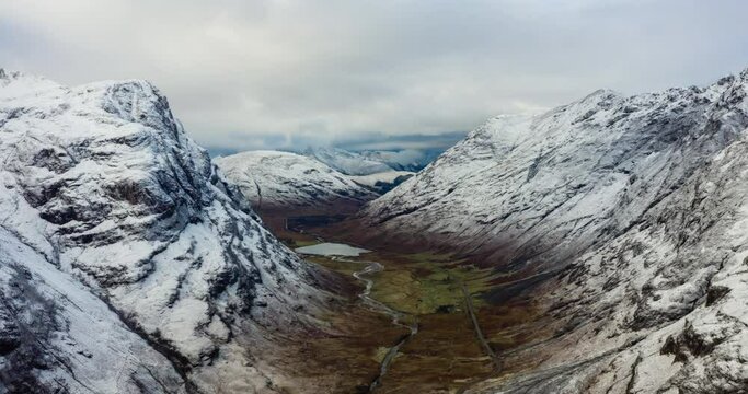 aerial view of Glen Coe in winter near rannoch moor in the argyll region of the highlands of scotland showing snow dusting on the mountains and munros