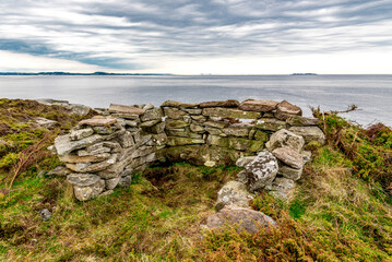 One of the old sentry fortifications made of rocks which surround historical Fjoloy fort, Rennesoy kommune, Stavanger, Norway, May 2018