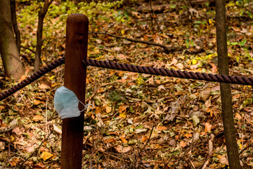 Obraz premium White medical face mask tied onto post