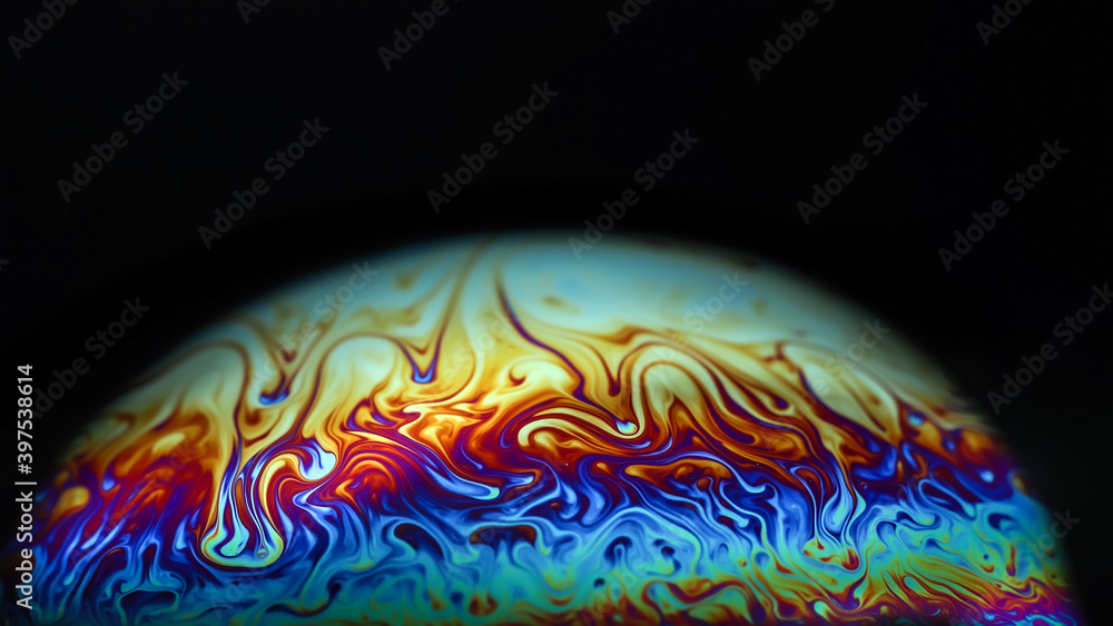Wall mural macro picture of half soap bubble on black ground look like abstract psychedelic color planet in spa