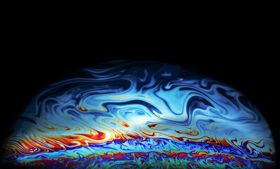 Macro picture of half soap bubble on black ground look like abstract psychedelic color planet in space