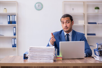 Young male employee unhappy with excessive work