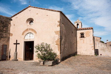 Fototapeta na wymiar Church in the old village of Populonia. View at the Church of Santa Croce in Populonia town - Italy