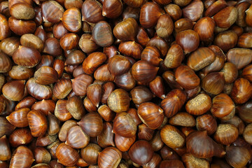 Full frame image of raw chestnuts for sale in a market stall.
