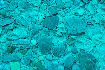 Abstract background of many large stones. Empty stone surface of turquoise color. Blank for design.