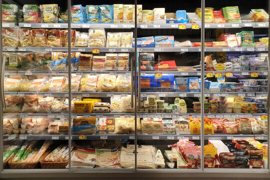 Interior view of huge glass freezer with various brand processed foods and beverages in Carrefour Express store. MILAN, ITALY - 25 OCT 2019.