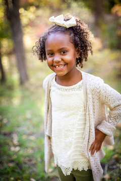 Outdoor Portrait of a beautiful smiling African American little girl. Adorable child laughing with a very cute expression on her face