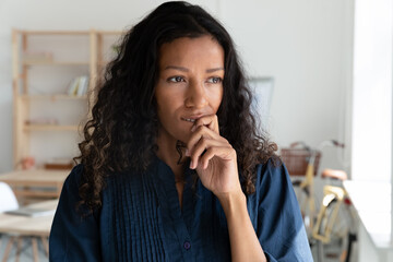 Fototapeta na wymiar Close up of thoughtful African American businesswoman look in window distance thinking or solving problem. Pensive biracial female employee plan or decide in office. Business vision concept.